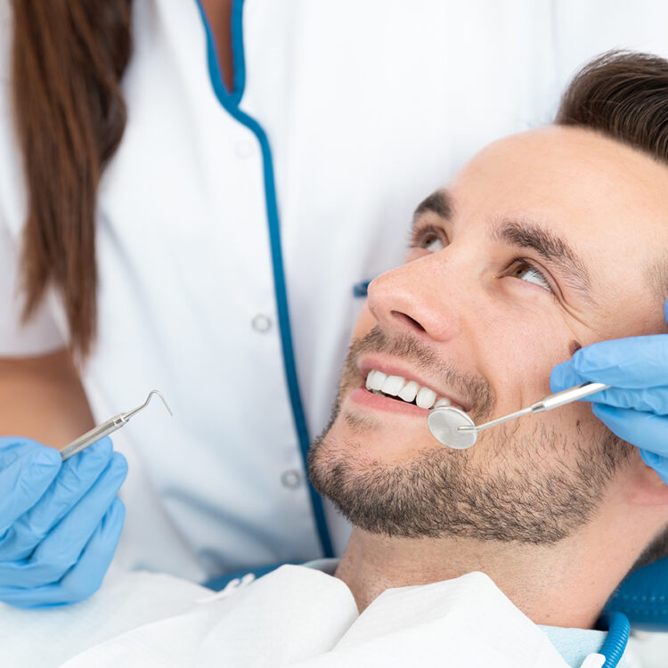 Man having teeth examined at dentists.