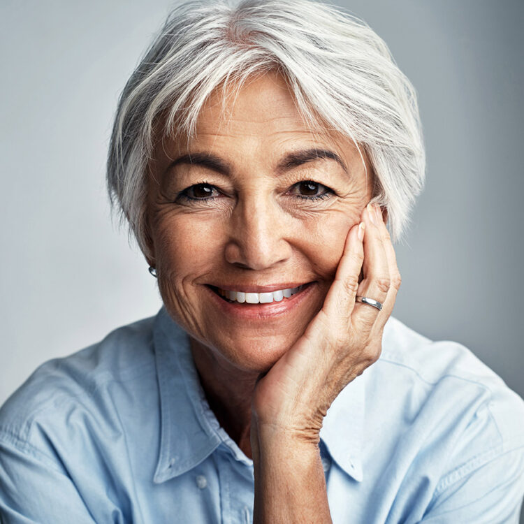 An image of a older woman with an incredible smile because of the dental work done at Renew Family Dental.