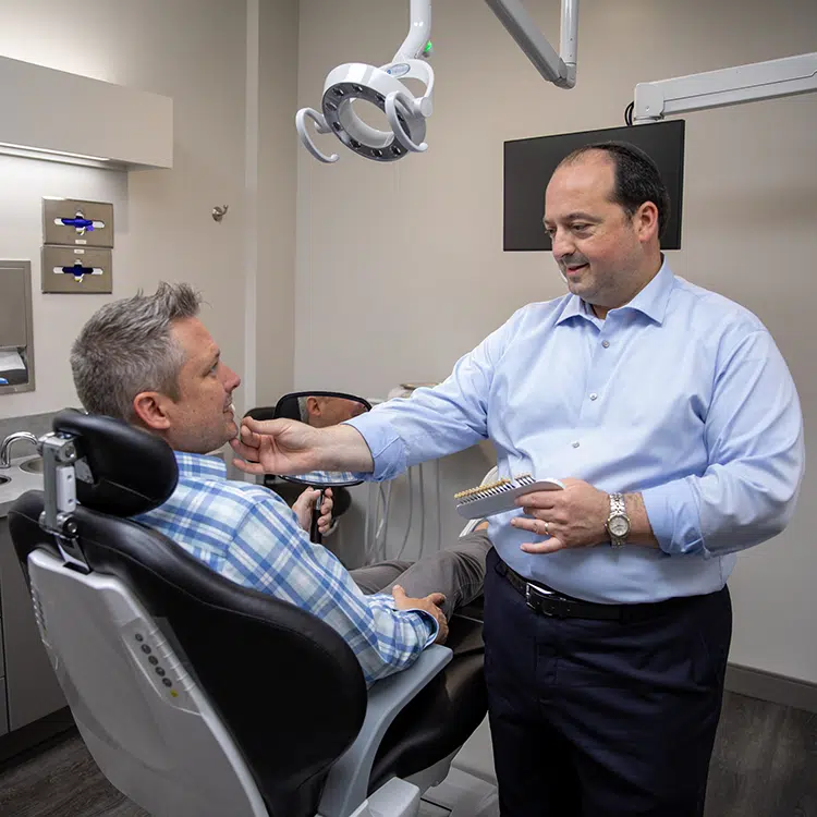 Max Nahon DDS helping patients at Renew Family Dental